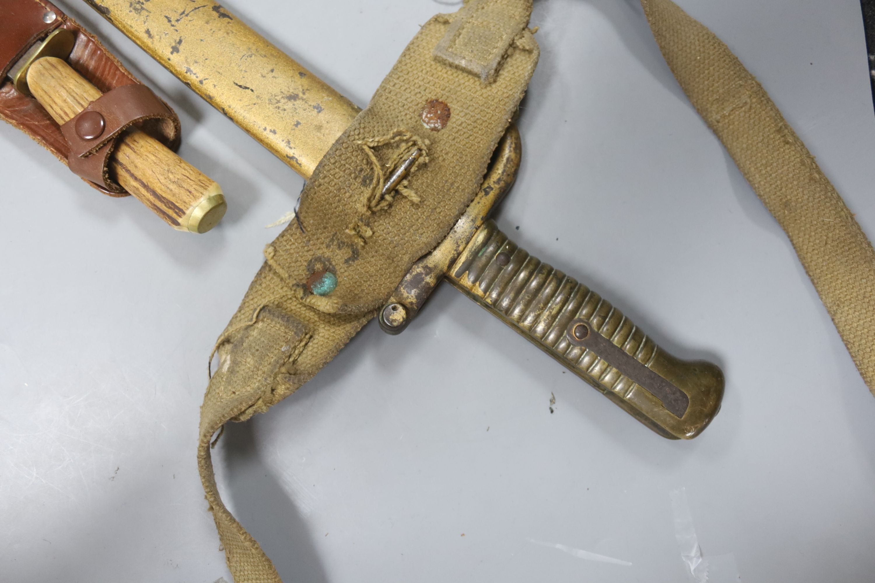 A bayonet with scabbard and a knife, bayonet 71 cms long.